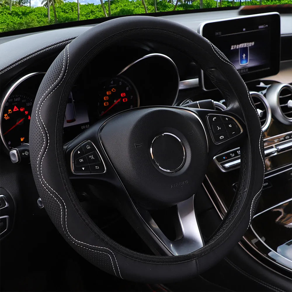 Black embossed corrugated elastic steering wheel cover shown fitted on a car steering wheel.