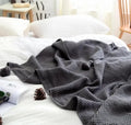 Nordic fringed knit ball blanket in beige colour showing textured design