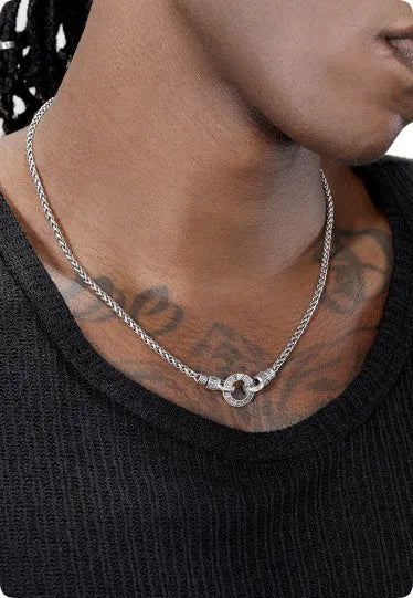 Close-up of a women's sterling silver clavicle necklace with a classic chain, shown against a neutral background.