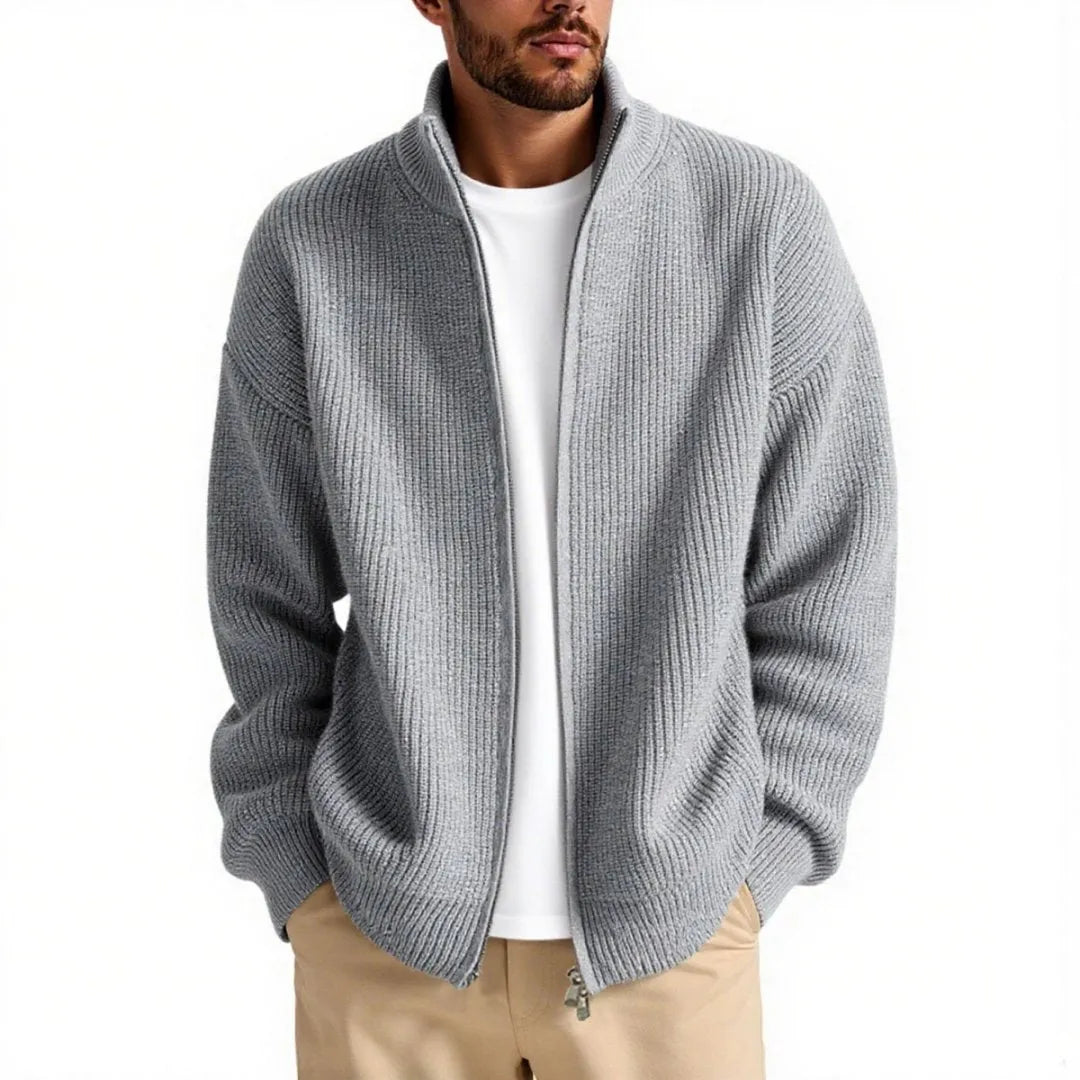 Man wearing a loose grey men's cardigan sweater, a casual acrylic knitwear piece for leisure.