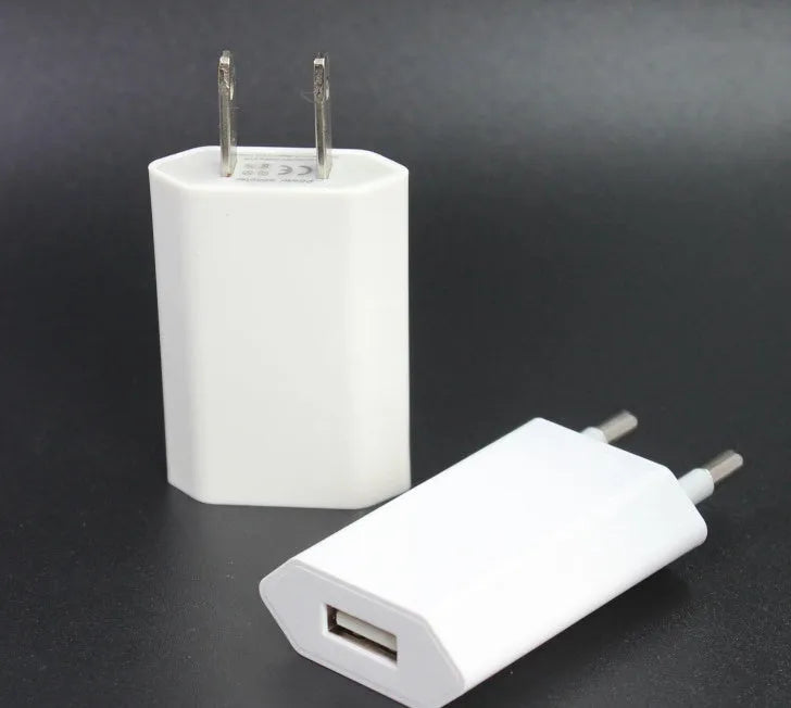 White USB wall charger and white Lightning cable for iPhone and iPad charging.
