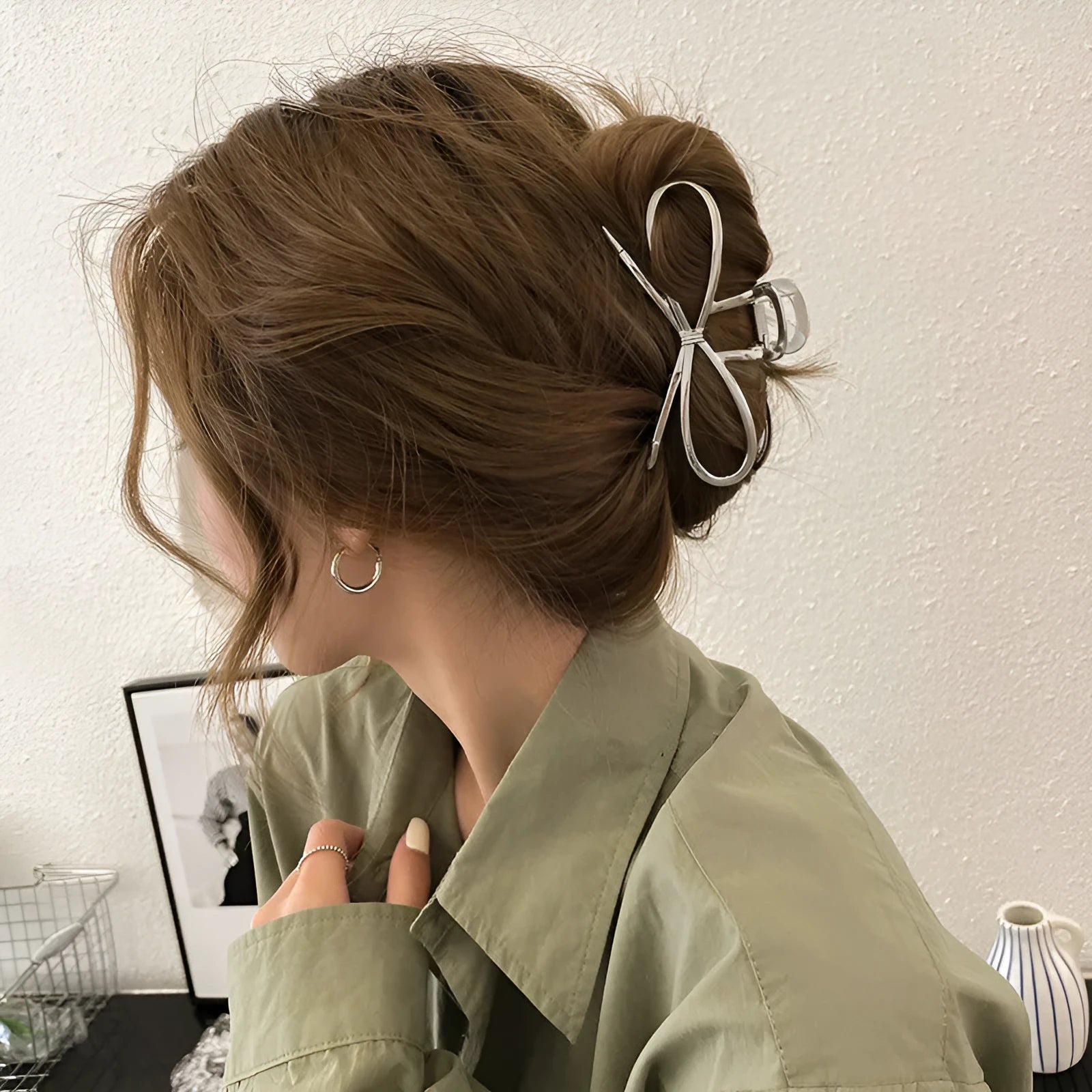 A silver women's hair barrette with a decorative Korean-style bow and an alloy clip.