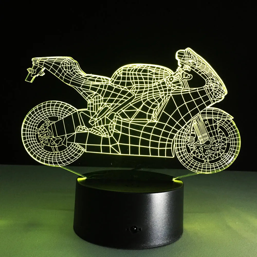 Motorcycle LED desk lamp with black base and acrylic shade showing orange colour