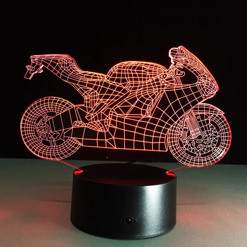 Motorcycle LED desk lamp with black base and acrylic shade showing orange colour