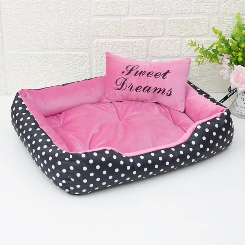 Polka dot printed square dog bed with a matching embroidery pillow in rose red, shown in a small size.