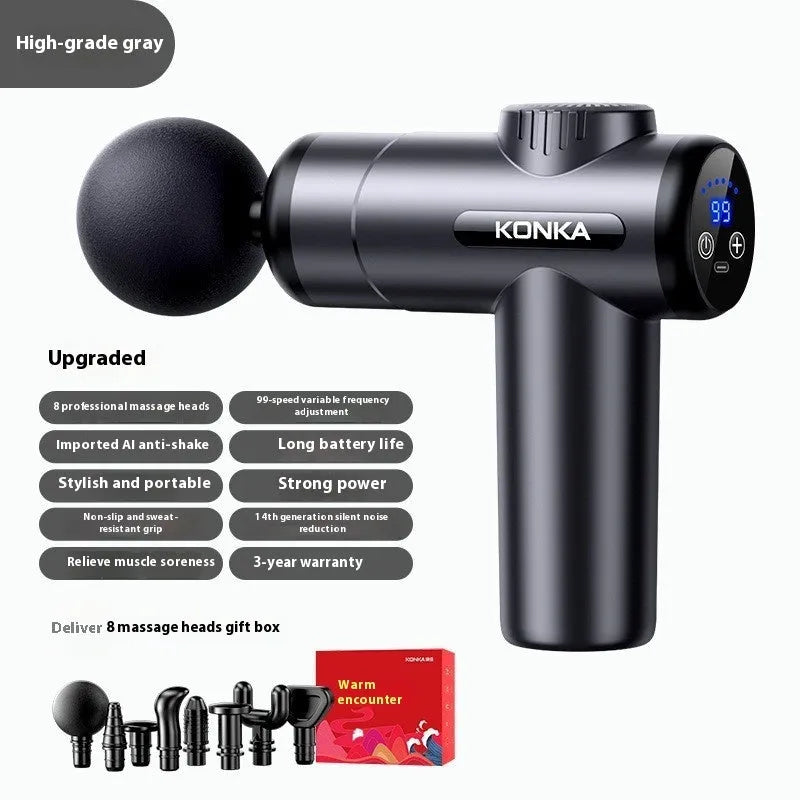 Konka V19 grey mini electric massage gun with multiple attachment heads on a table