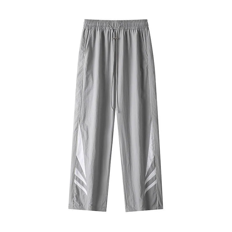 Men's straight leg summer sports trousers in grey, showing loose fit and button fly.