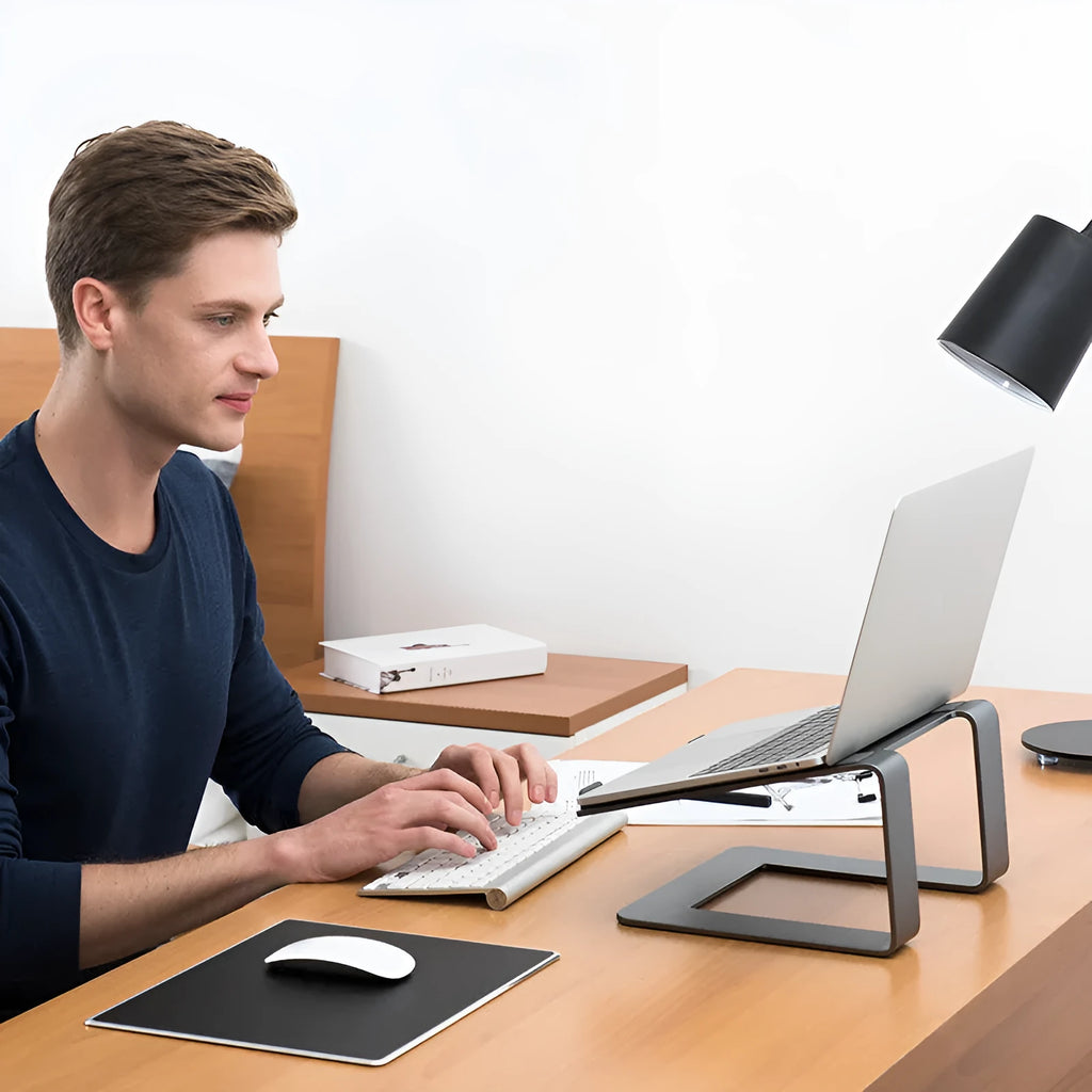 Aluminium alloy laptop stand on desktop in black colour with laptop elevated