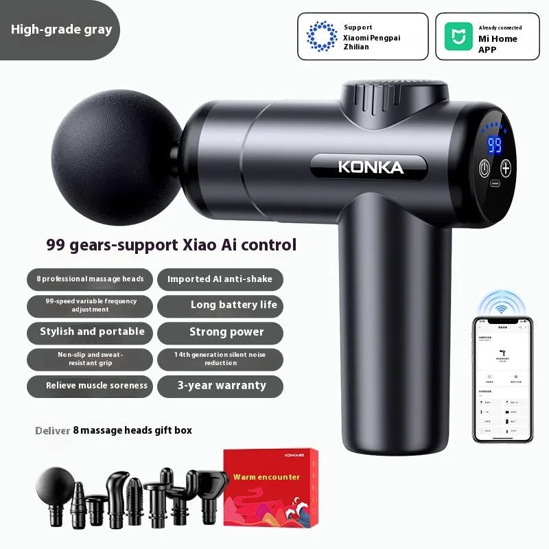 Konka V19 grey mini electric massage gun with multiple attachment heads on a table