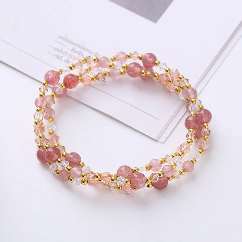 Adjustable bracelet with tourmaline, strawberry quartz, and amethyst crystals in a three-ring design.