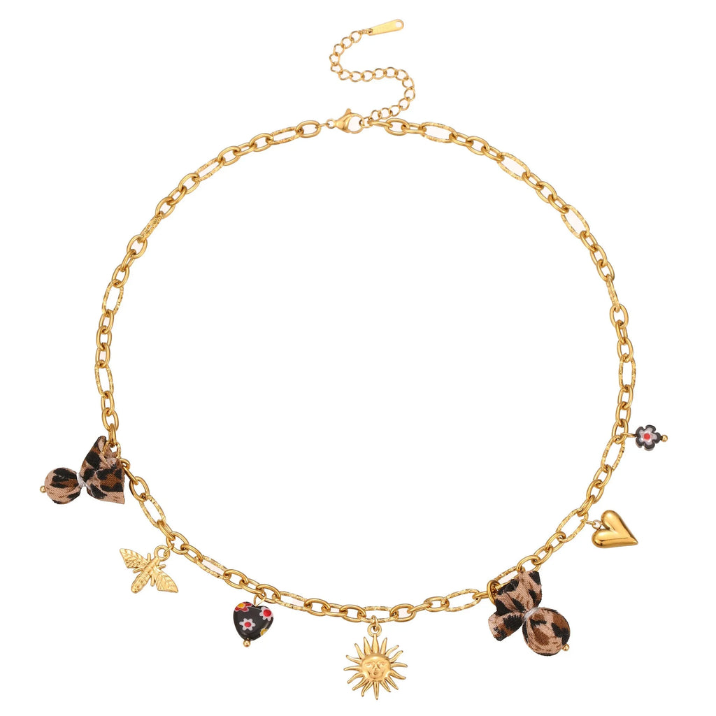 Gold-plated leopard pendant necklace with love heart and flower detailing on adjustable chain
