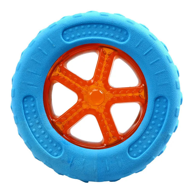 Set of three floating TPR dog toys: a blue ball, an orange barbell, and green tyres on a pool edge.