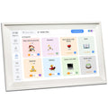 White smart digital photo frame with 15.6 inch screen on a table, showing family photos.