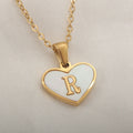 Gold heart necklace with white shell detail and personalised initial letter on adjustable chain