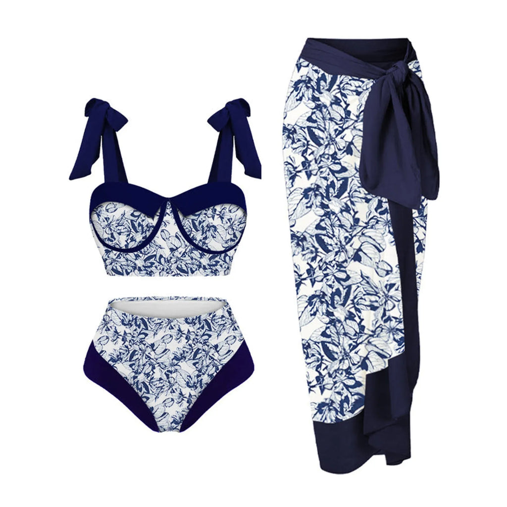 Women's pink printing split swimsuit three-piece set with skirt, bra, and panties on a mannequin.