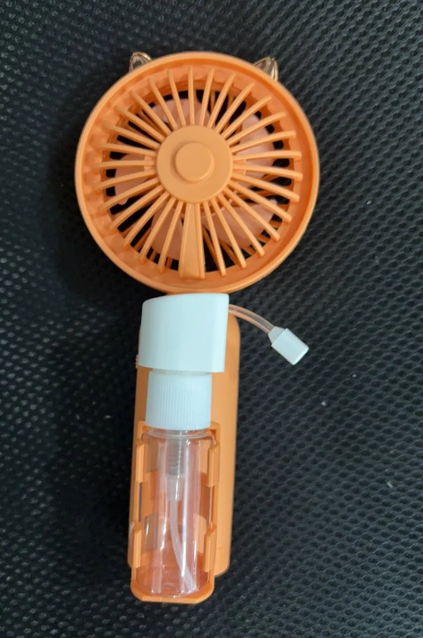 A handheld USB personal fan in one of five colours: apricot, blue, green, orange, or pink, showing its plastic nozzle and compact size.
