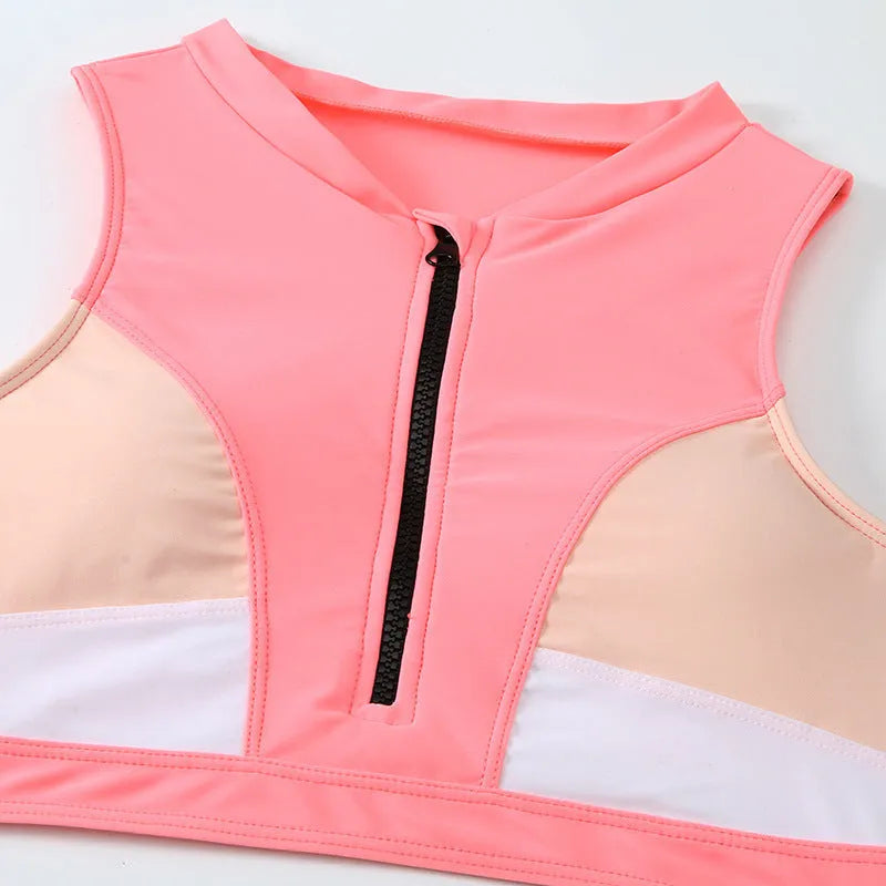 Pink high-waist bikini swimsuit with split-leg briefs and matching bra on a mannequin.