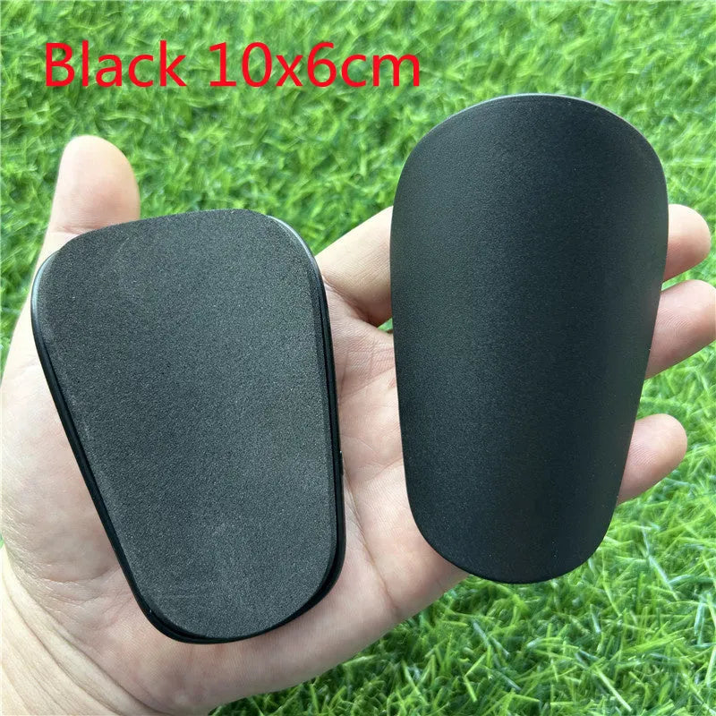 Extra small mini plastic football shin guards in black and white 8x5cm sizes
