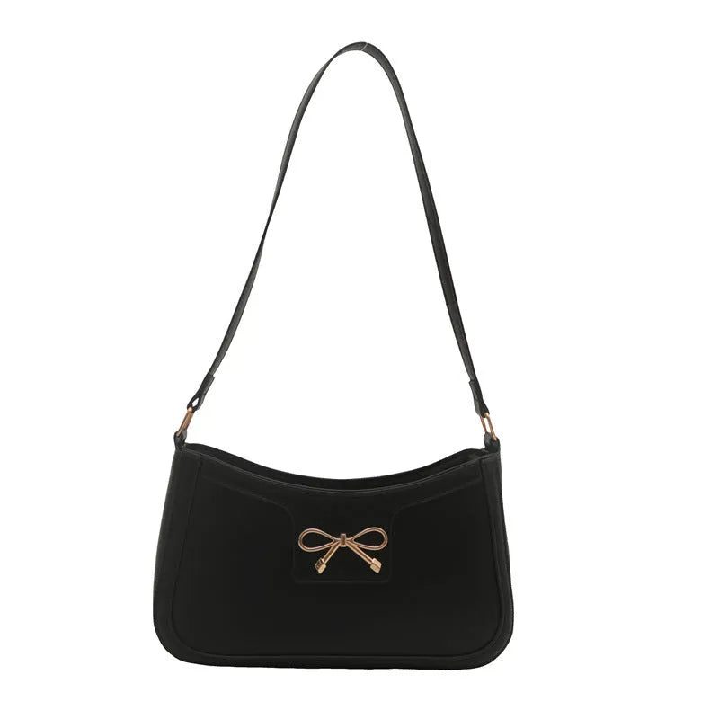 Western style baguette shoulder bag with bow detail showing horizontal square shape