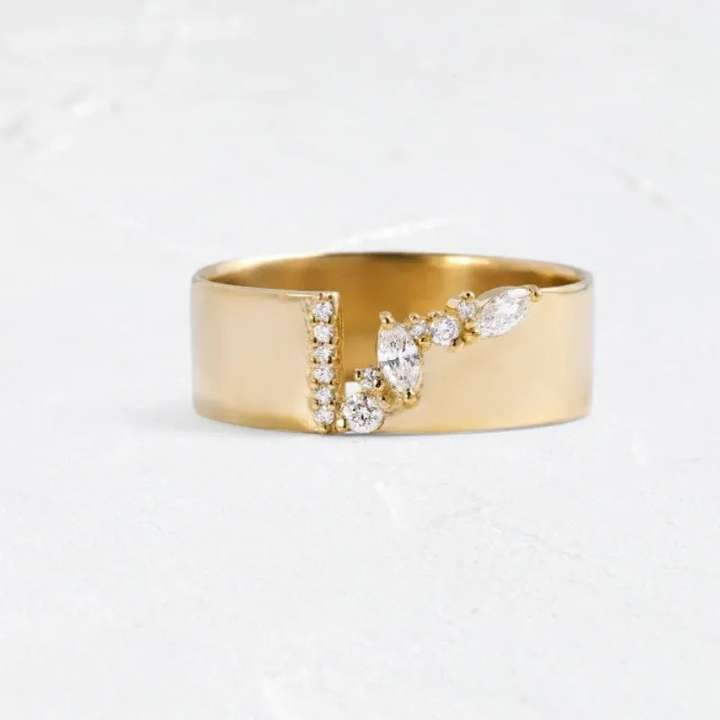 Gold electroplated women's ring with a shining zircon stone, shown on a finger.
