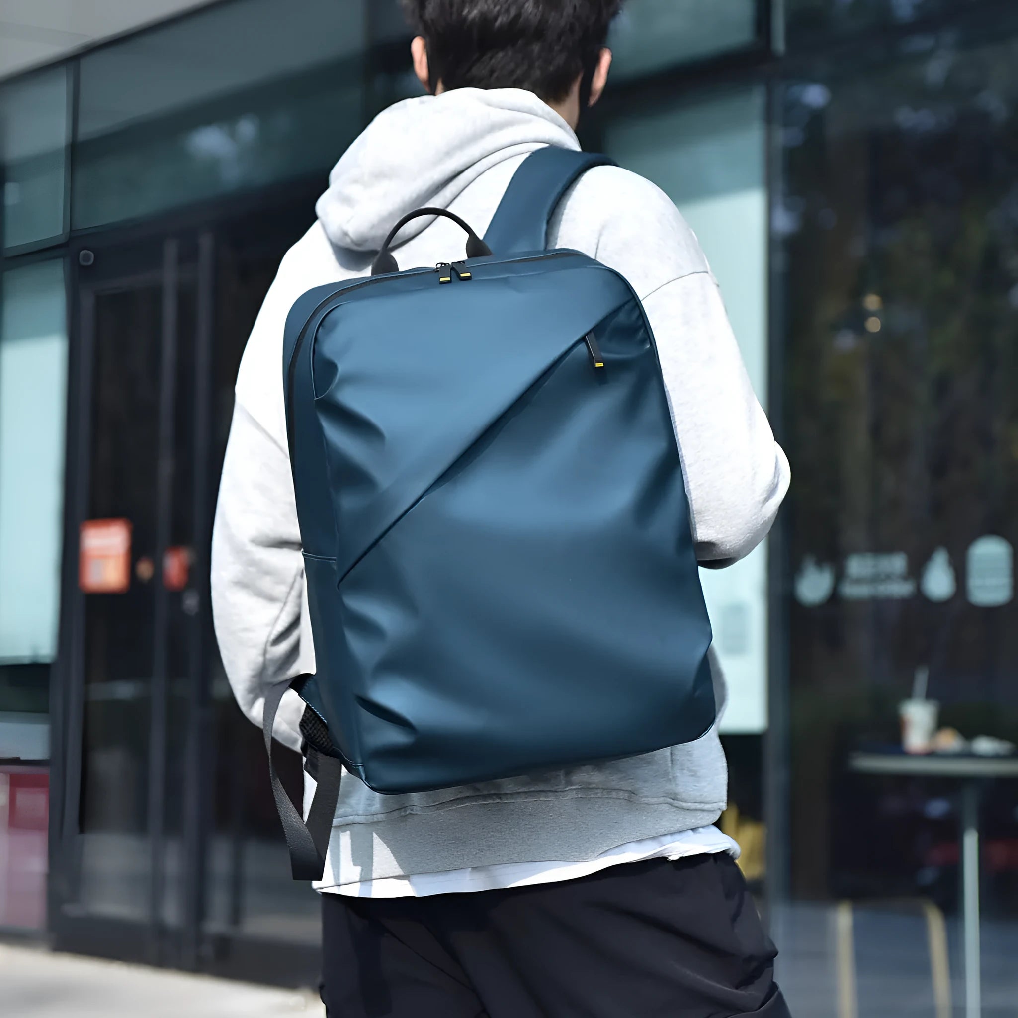 Large black waterproof PU leather backpack for men with sewing thread detailing and computer bag