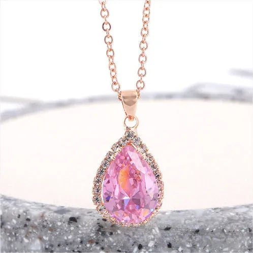 Rose gold water drop shape necklace with rhinestone geometric detailing in pink colour