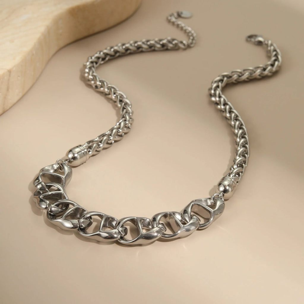Gold plated stainless steel geometric chain necklace for women on a white background.
