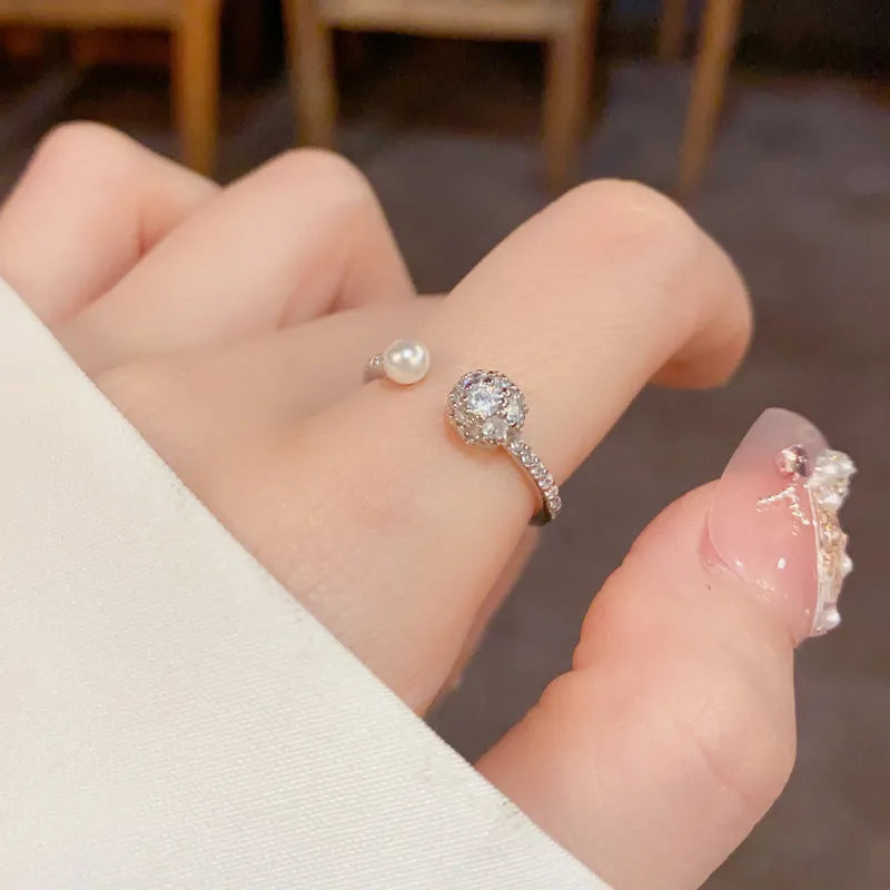 Gold plated open-end ring with round zircon pearl element on copper base
