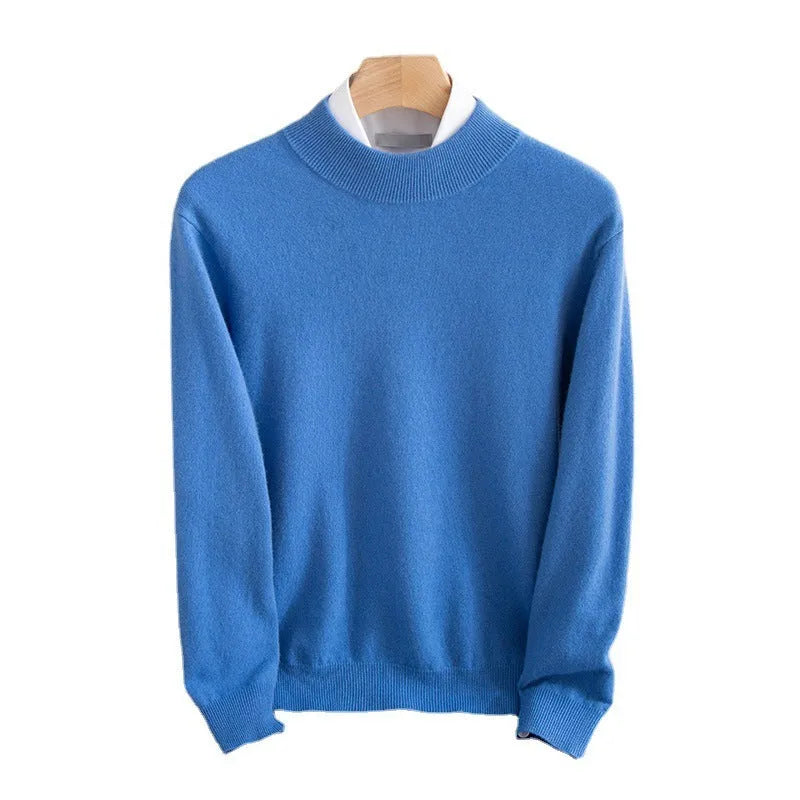 Man wearing a loose-fit, chunky knit wool sweater with a half-turtleneck collar in a neutral colour.