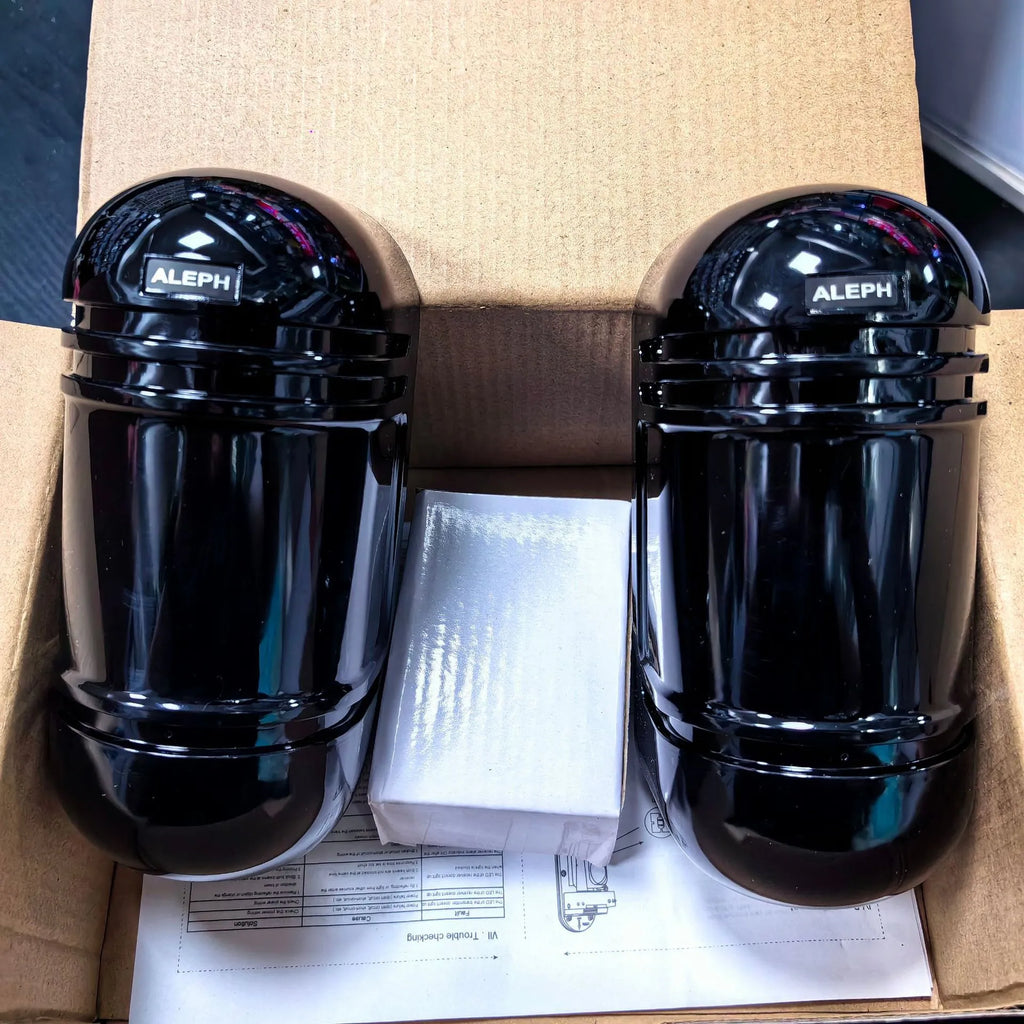 A pair of black wired infrared security detectors for 150-metre perimeter alarm systems.