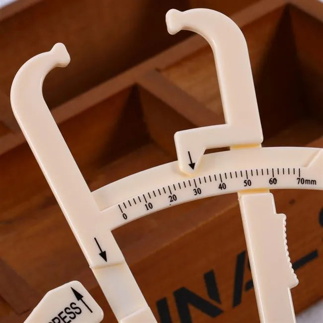 Acrylic body fat caliper with measurement scale showing 0.001mm accuracy