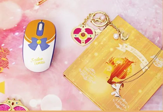 Pink Sailor Moon wireless computer mouse with USB receiver on desk