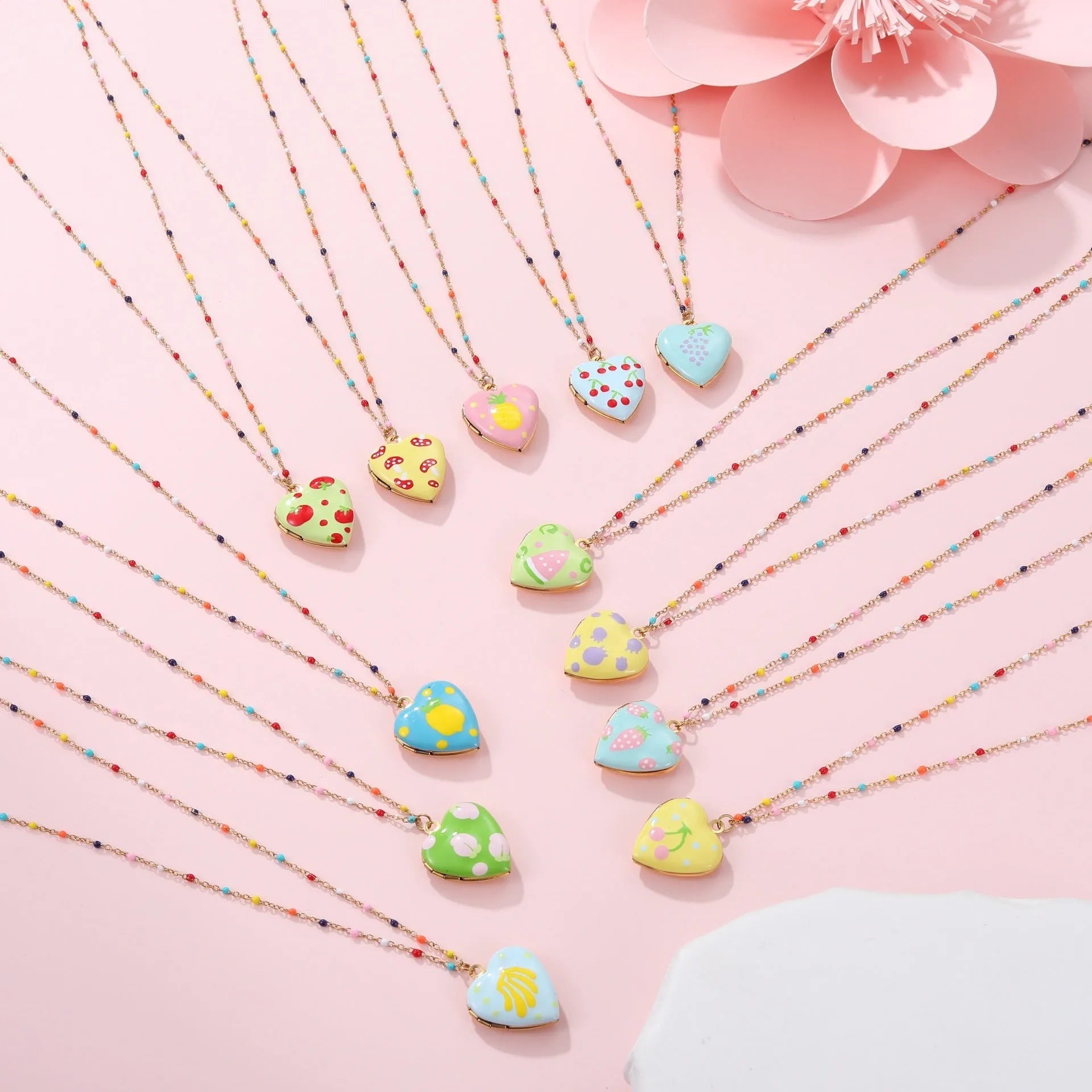 Gold-plated heart-shaped fruit pendant necklace on a stainless steel chain, showing grape design detail.