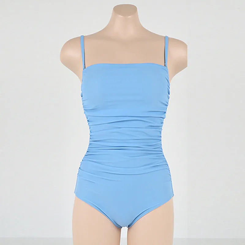Sling neck one-piece swimsuit with belly pleating in slim-fit design, available in blue, white, yellow, and black colours