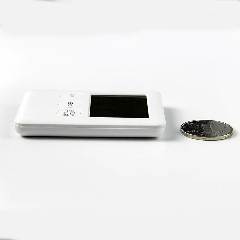 Black and white magnetic kitchen timer with large digital display on a refrigerator.