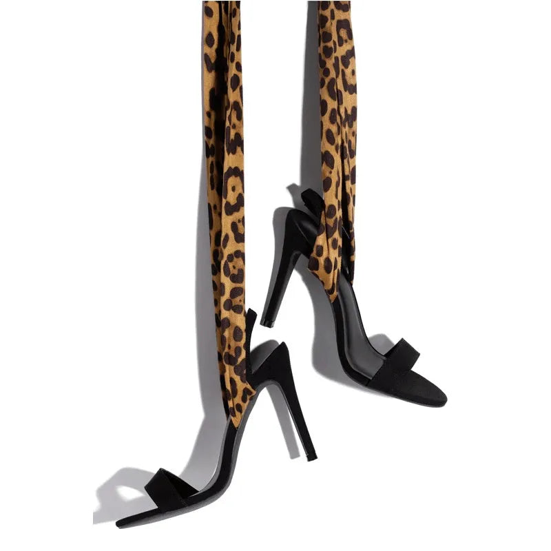 Light brown leopard print women's high heels with cross straps and a thin high heel.