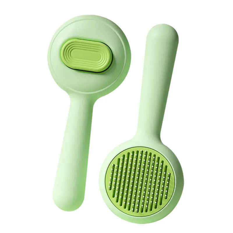 Green and yellow cat grooming brush with stainless steel comb teeth and a non-slip handle.