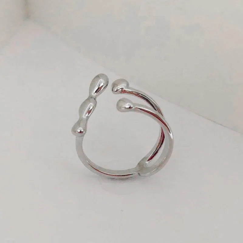 Adjustable brass opening ring with circular sphere element in gold or silver finish
