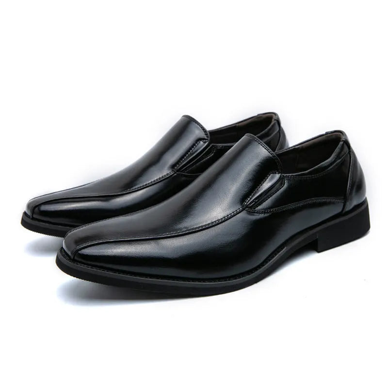 Men's black pointed casual shoes with a patent leather look and flat rubber sole.