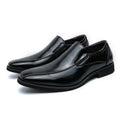 Men's black pointed casual shoes with a patent leather look and flat rubber sole.