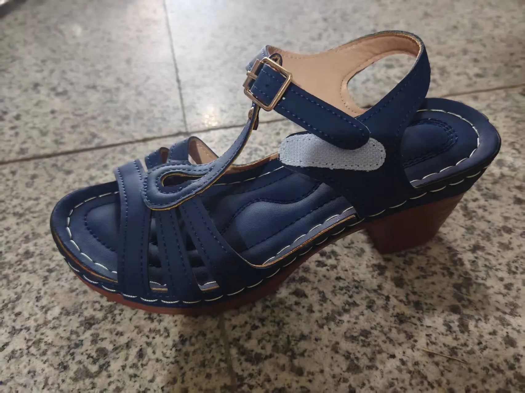Women's black peep toe wedge sandals with a buckle fastening and platform sole.