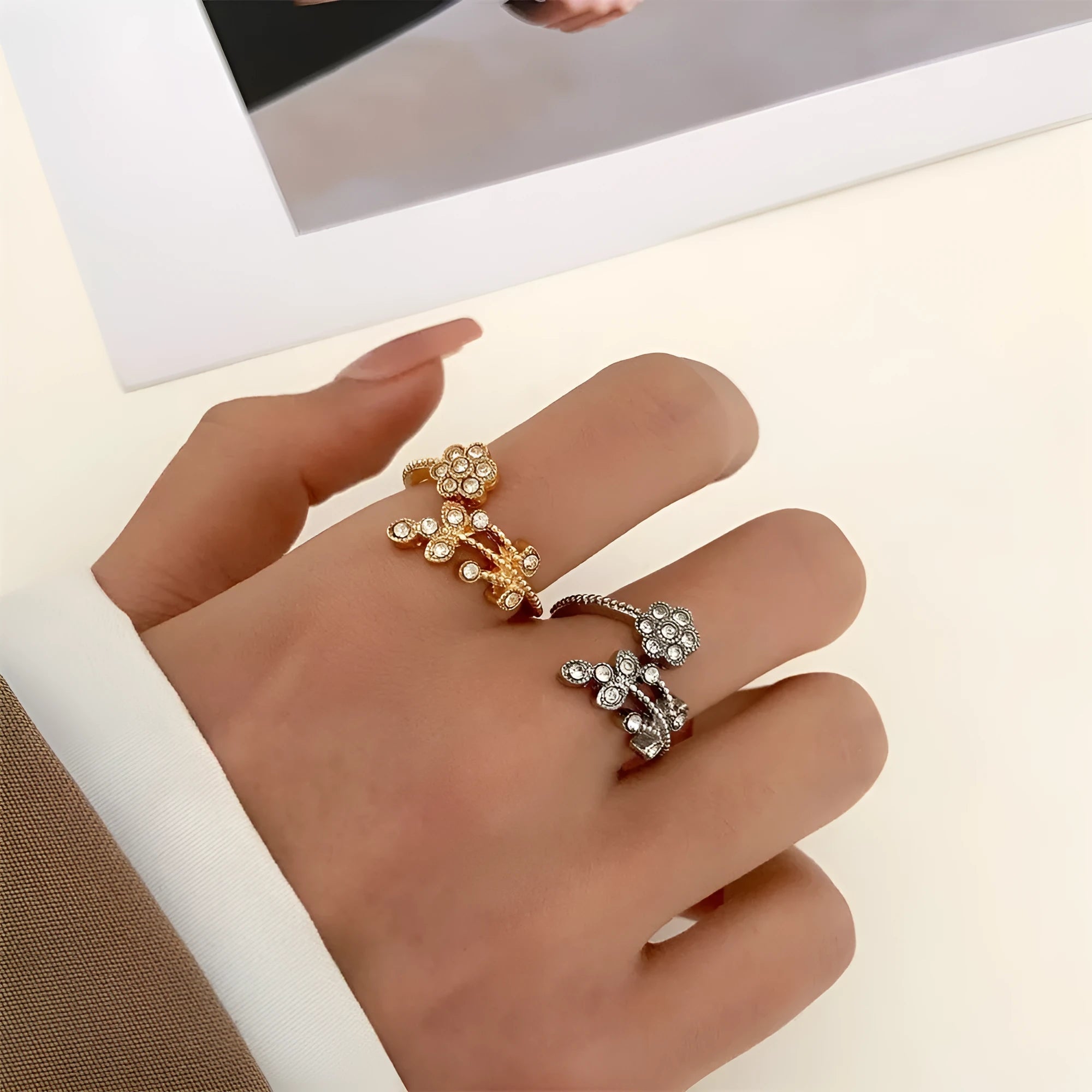 Women's open ring with diamond flower and leaf pattern in copper, shown in gold and white colour options.