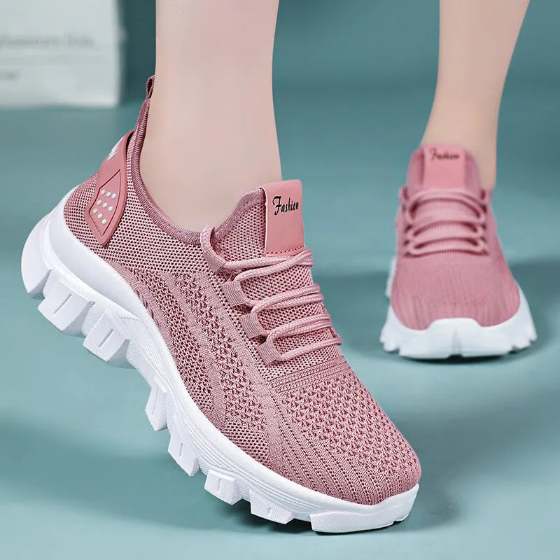 Women's white Flyknit sneakers with a thick PVC sole and front lace-up on a plain background.