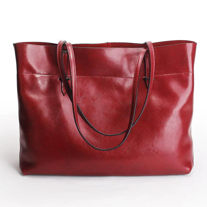 Brown waxed cowhide leather crossbody handbag showing two compartments and phone pocket