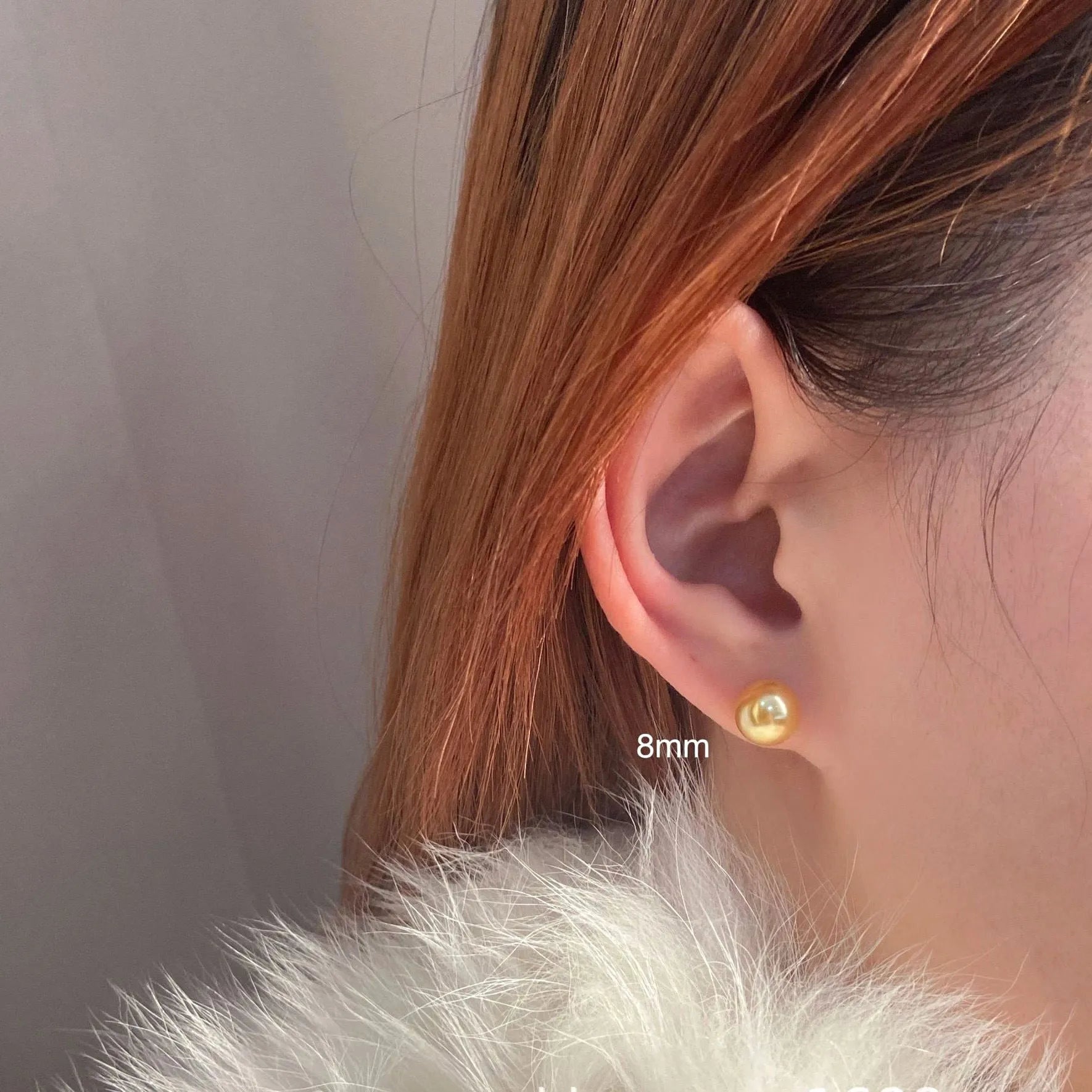 A pair of large silver pearl stud earrings with an eight-pointed star geometric design on a white background.