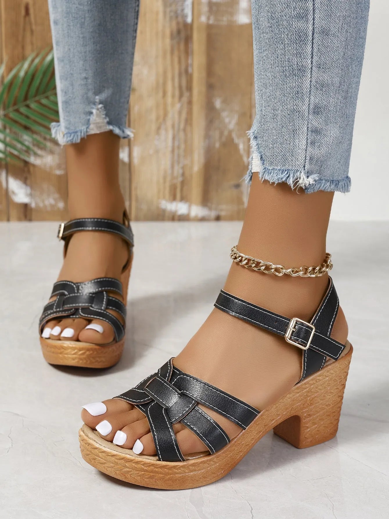 Plus size black women's sandals with peep toe, chunky heel, and ankle buckle strap on a white background.