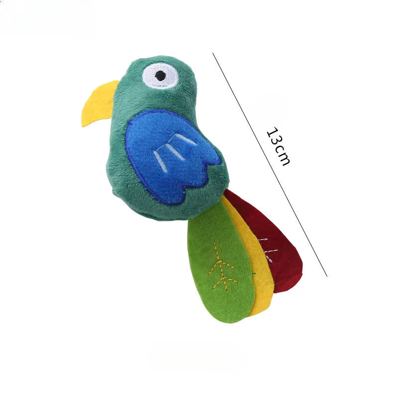 Colourful plush cat toy shaped like a cow, a crocodile, or a parrot on a plain background.