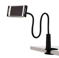 Black bedside oversize flat panel phone holder with a long flexible arm mounted on a table.