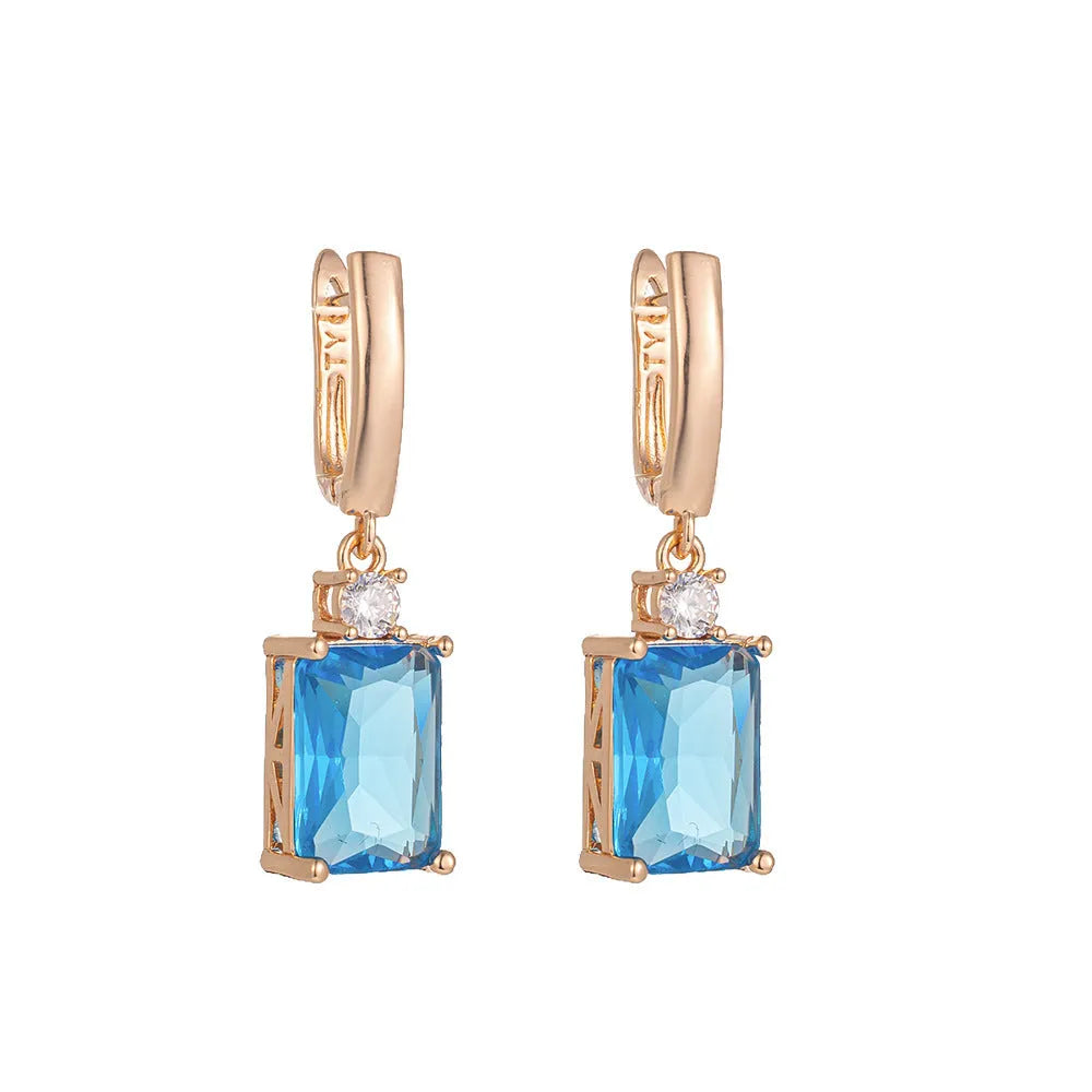 A pair of square geometric stud earrings with a quadrilateral design in an electroplated gold or silver finish.