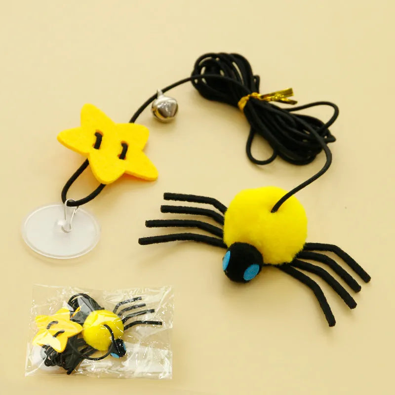 Red and yellow door-hanging cat toy with elastic rope, feather, bell and spider attachment for indoor feline play